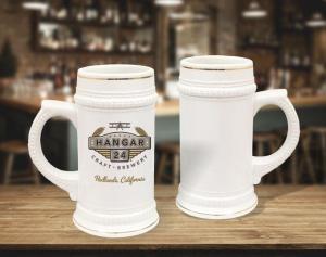 22 oz white with gold trim beer steins staged on bar