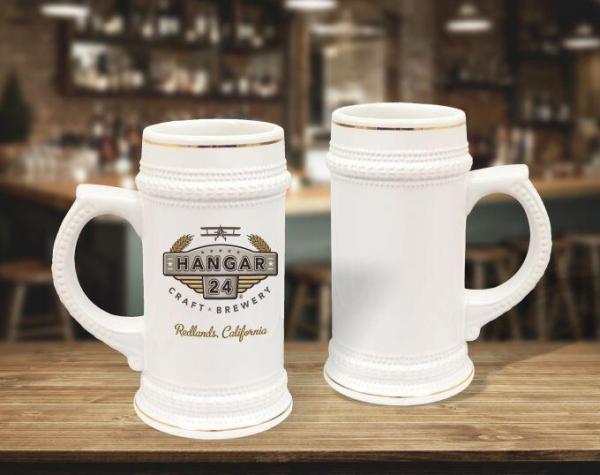 22 oz white with gold trim beer steins staged on bar